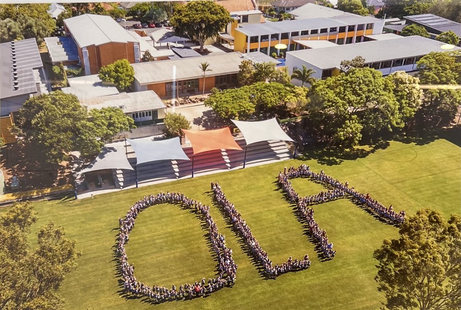 Staff and students gathered on the oval to make the letters OLA